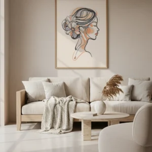 Affiche portrait femme floral en dessin au trait, profil avec fleurs dans les cheveux, encadrée en bois au-dessus d’un canapé beige.
